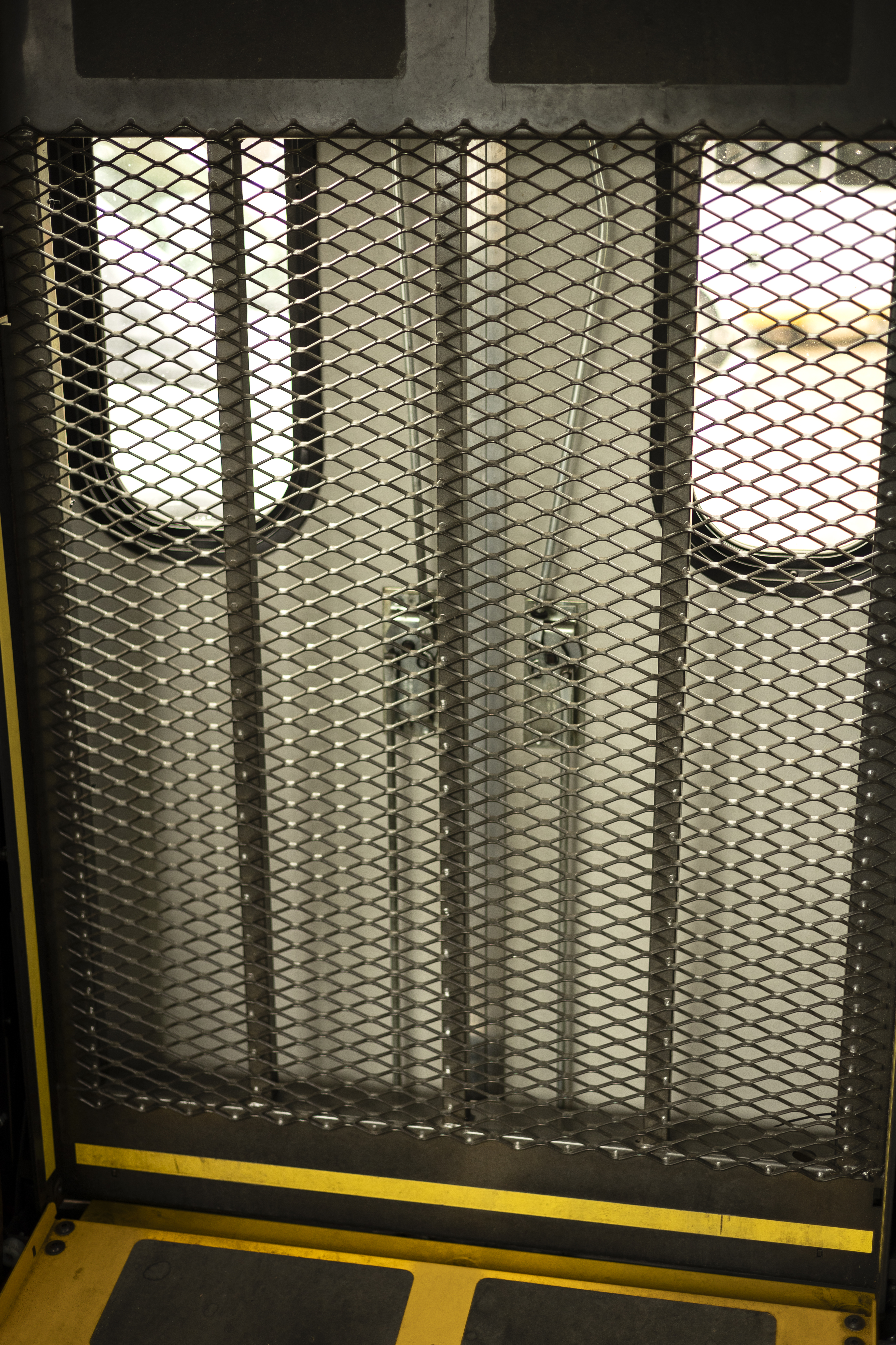 A wheelchair lift is shown in the back of a Ford E-350 cutaway with mobility van upfits.